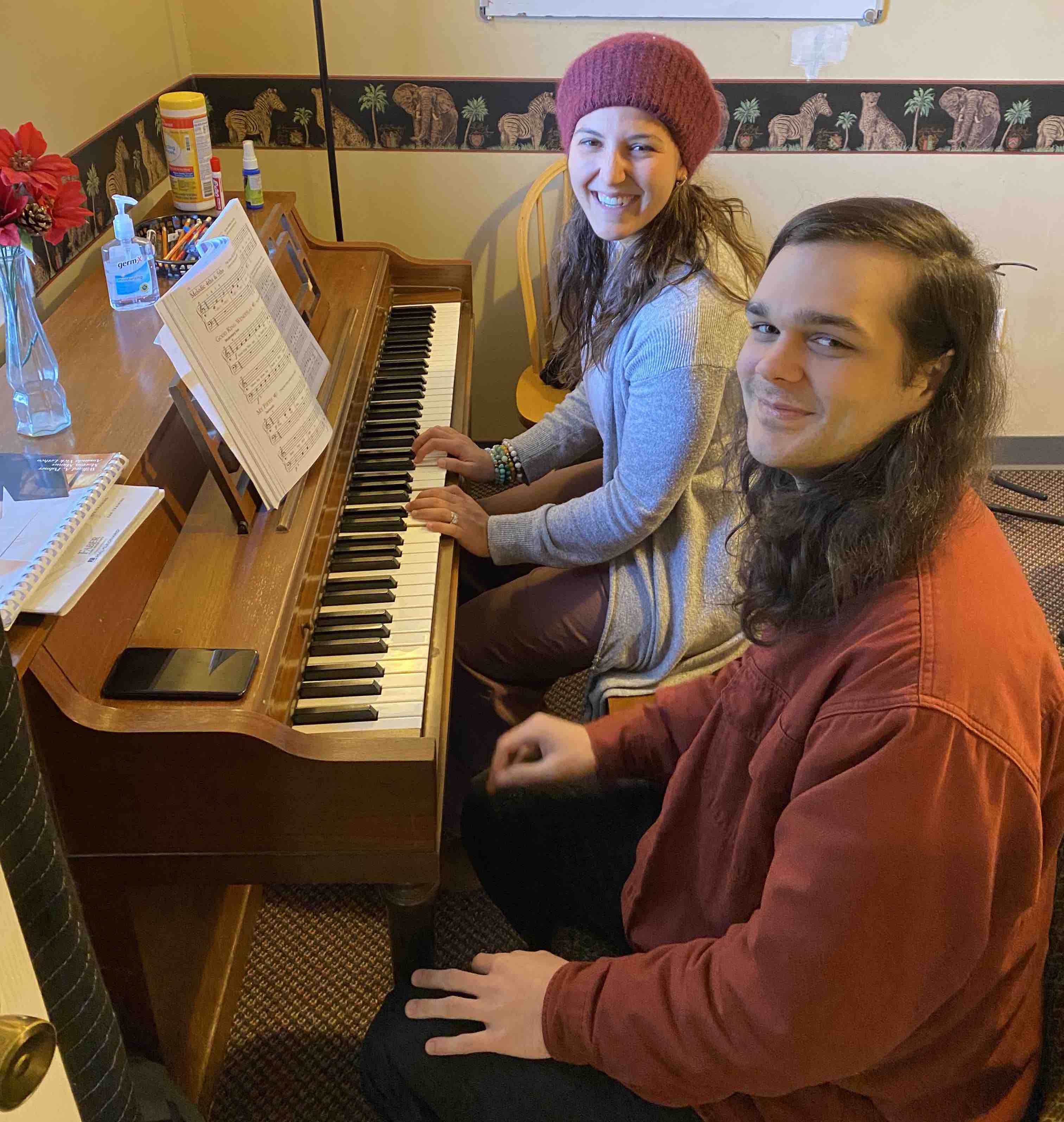 Teacher and student learning piano